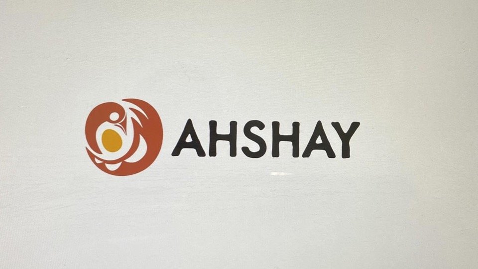 Logo - stylized bird protecting an egg. AHSHAY